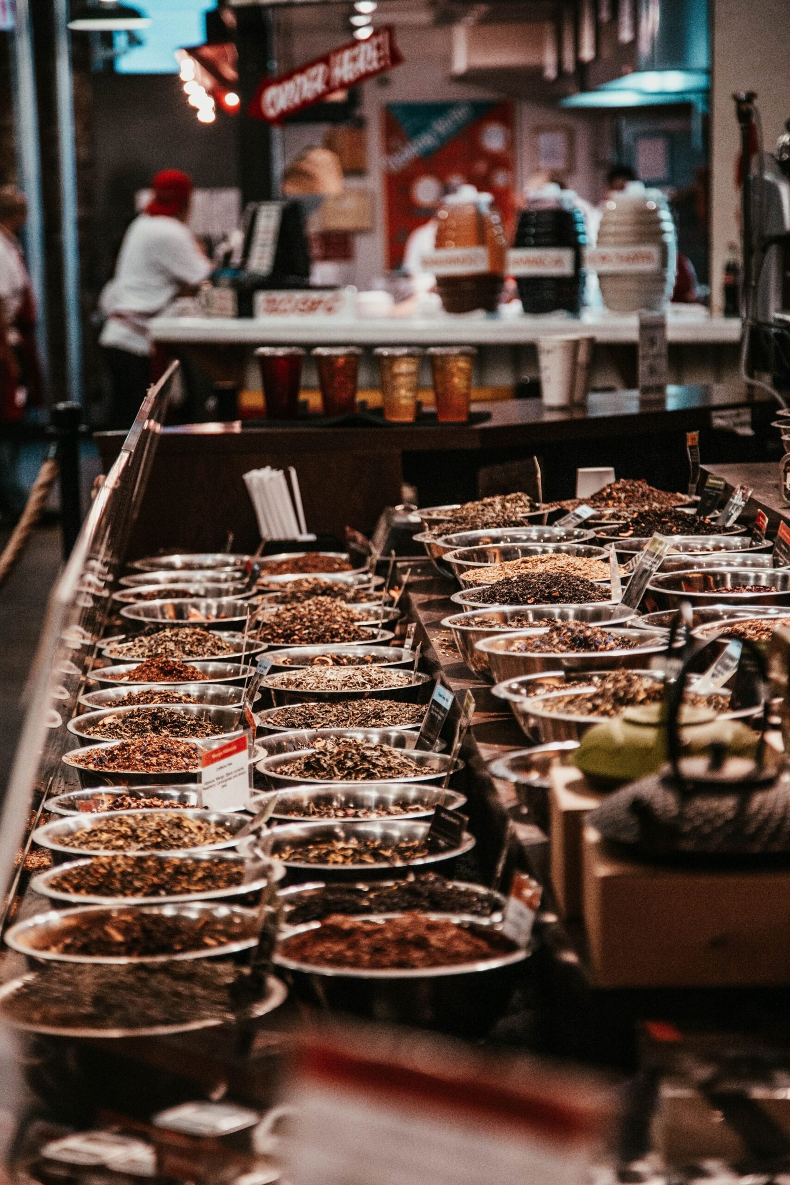 Colorful spice stall in New York City market, showcasing diverse aromatic herbs and spices.